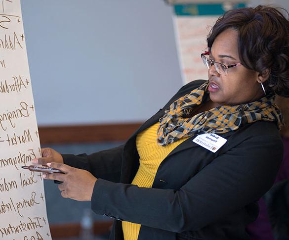 Extension staff member writing on flipchart